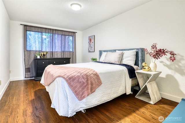 bedroom featuring dark wood-type flooring