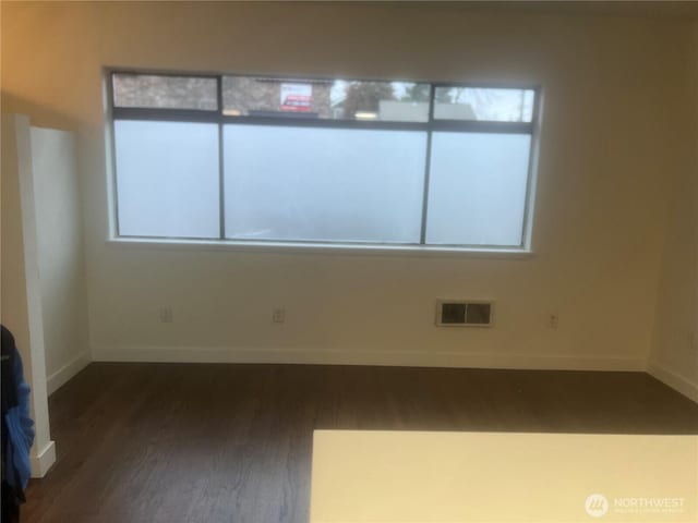 spare room featuring dark hardwood / wood-style floors