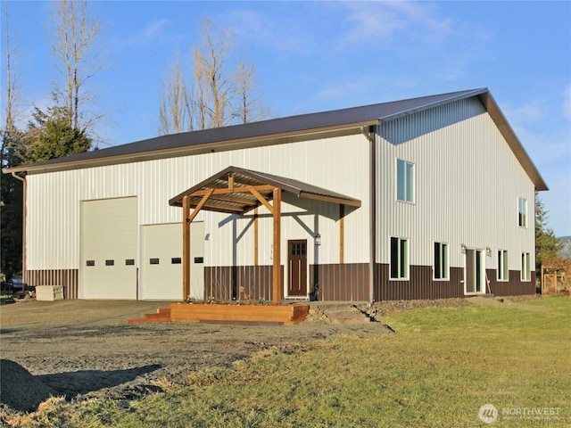 exterior space with an outbuilding, a garage, and a front yard