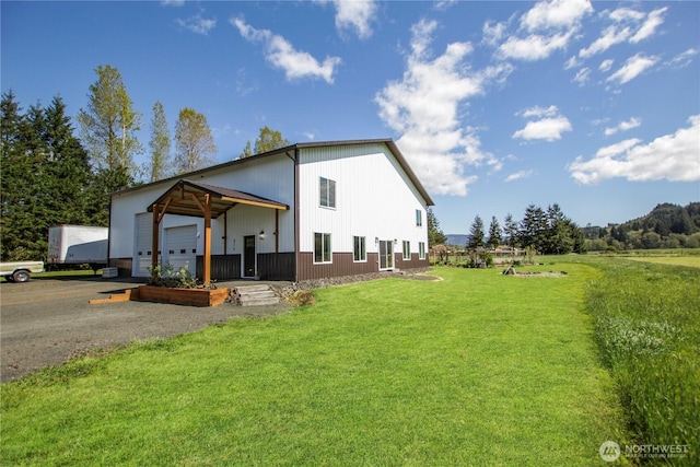 314 E Valley Rd, Skamokawa, WA 98647 - view of side of property with a yard, gravel driveway, and a garage