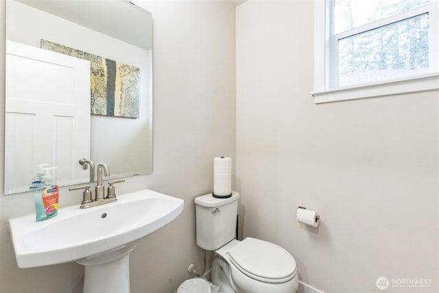 bathroom featuring toilet and a sink