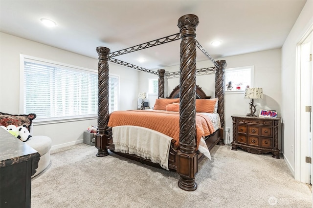 bedroom with light carpet and baseboards