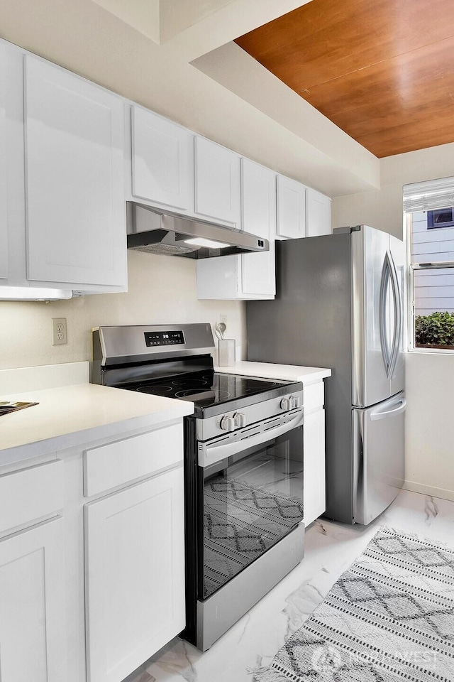 kitchen featuring white cabinetry, stainless steel appliances, and wooden ceiling