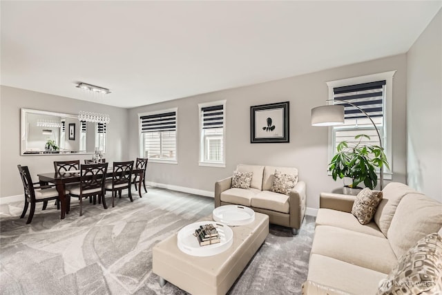 carpeted living area featuring baseboards