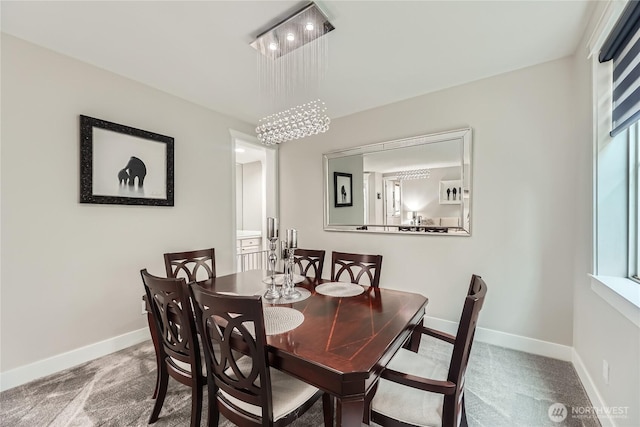 carpeted dining space with baseboards