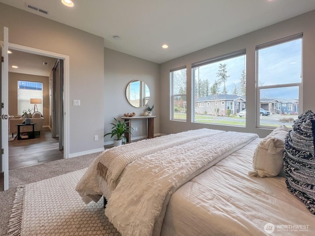 carpeted bedroom with recessed lighting, visible vents, lofted ceiling, and baseboards