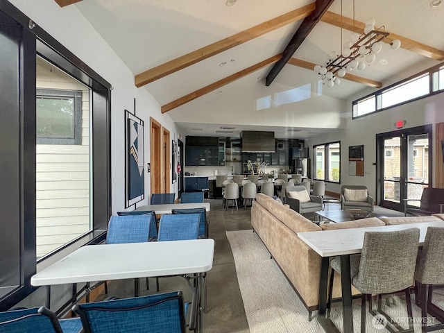 interior space featuring a chandelier, high vaulted ceiling, concrete floors, french doors, and beamed ceiling