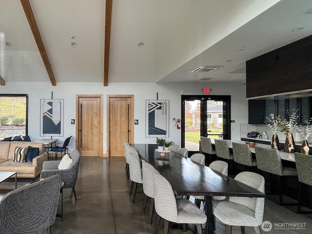 dining area with finished concrete flooring, visible vents, and beam ceiling