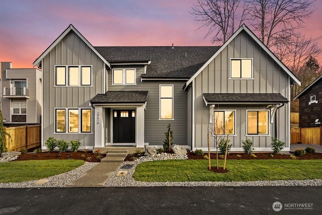 modern inspired farmhouse with a lawn