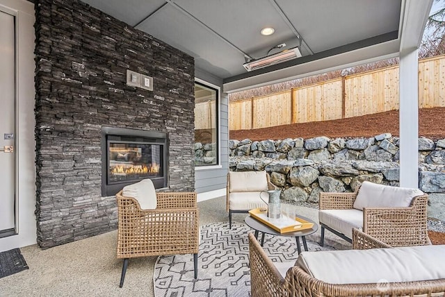 view of patio / terrace with an outdoor living space with a fireplace