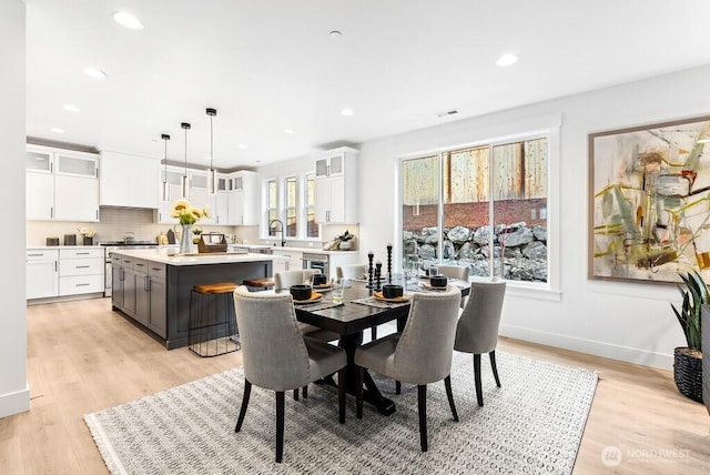 dining area featuring light hardwood / wood-style floors and sink