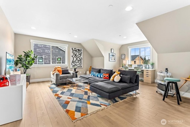 living room with lofted ceiling and light hardwood / wood-style flooring