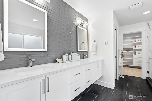 bathroom featuring tile patterned floors, vanity, and decorative backsplash