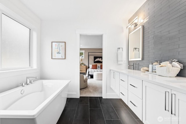 bathroom with tile patterned floors, backsplash, vanity, and a bath