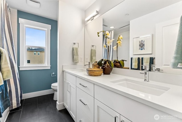 bathroom featuring tile patterned floors, toilet, and vanity