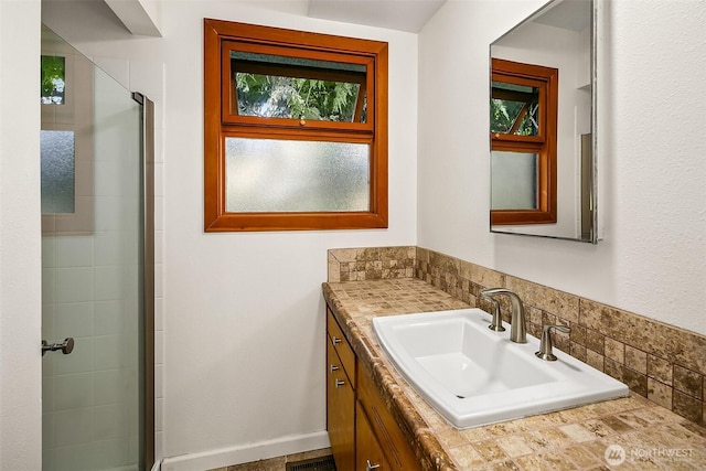 full bath featuring a stall shower and vanity