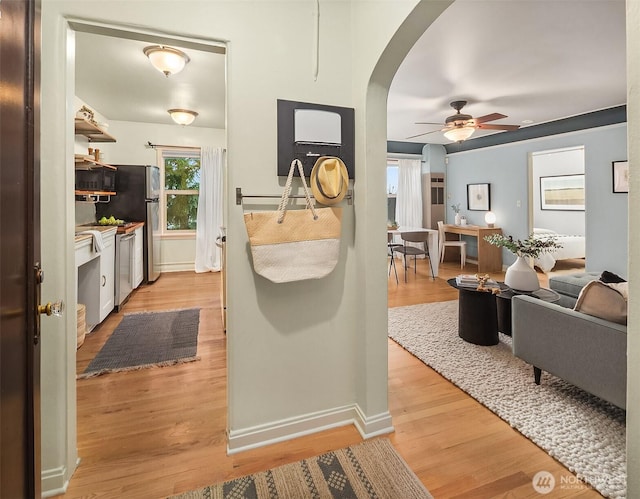 kitchen featuring white cabinetry, dishwasher, ceiling fan, and light wood-type flooring