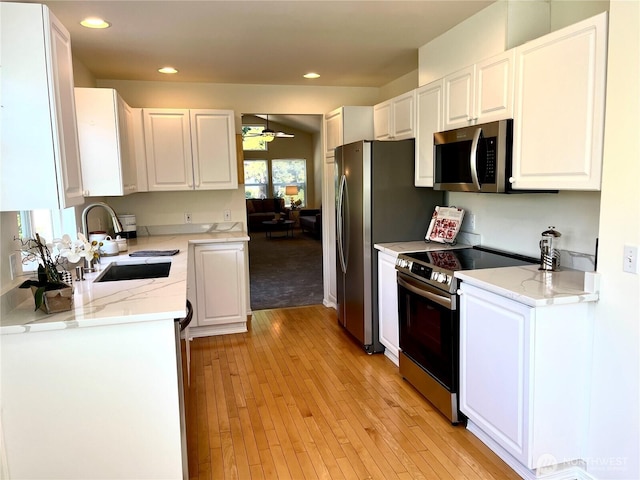 6019 Nathan Way SE Unit A, Auburn, WA 98092 - kitchen featuring appliances with stainless steel finishes, white cabinets, light wood-style floors, a ceiling fan, and recessed lighting