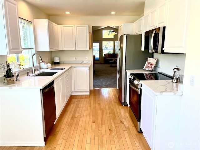 6019 Nathan Way SE Unit A, Auburn, WA 98092 - kitchen with stainless steel appliances, white cabinets, plenty of natural light, and recessed lighting