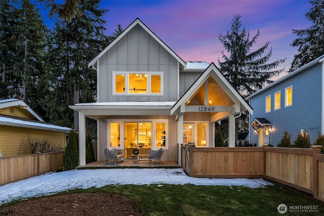 back house at dusk with a porch