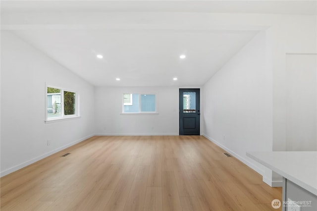 interior space featuring light wood-type flooring and lofted ceiling