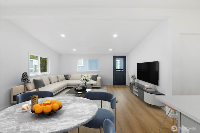 living room with vaulted ceiling and light hardwood / wood-style flooring