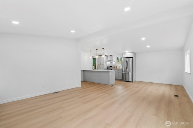 unfurnished living room with light hardwood / wood-style flooring and sink