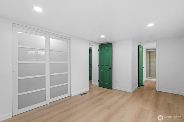 spare room featuring light wood-type flooring