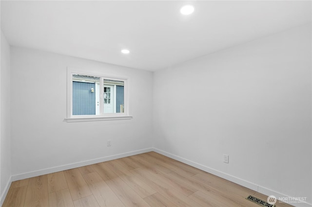 empty room with light hardwood / wood-style floors