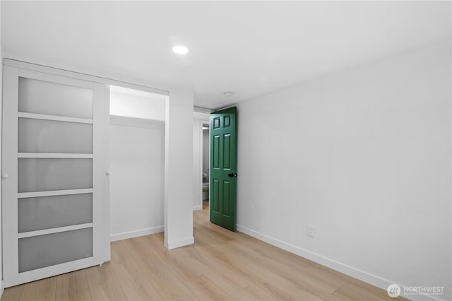 unfurnished bedroom featuring a closet and light hardwood / wood-style flooring