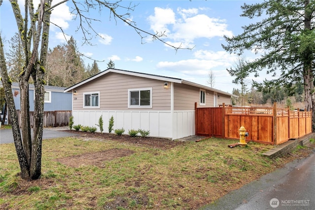 view of side of home featuring a yard