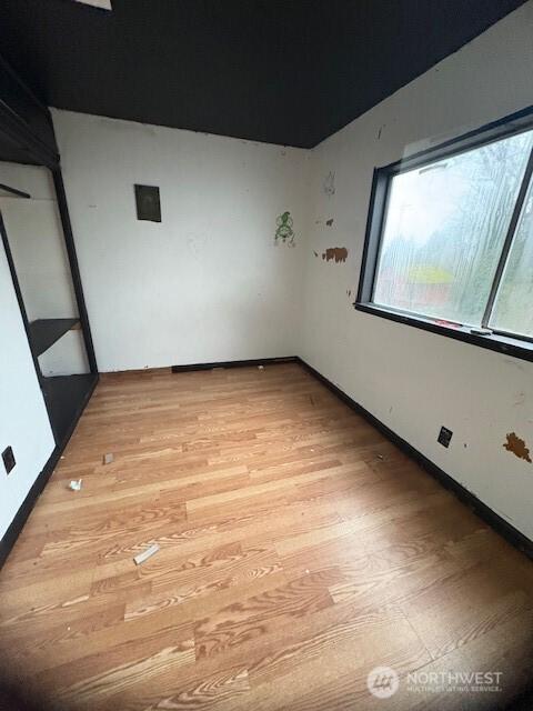 unfurnished room with light wood-type flooring