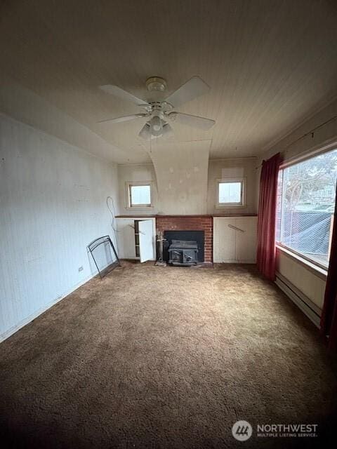 unfurnished living room featuring ceiling fan, carpet, and baseboard heating