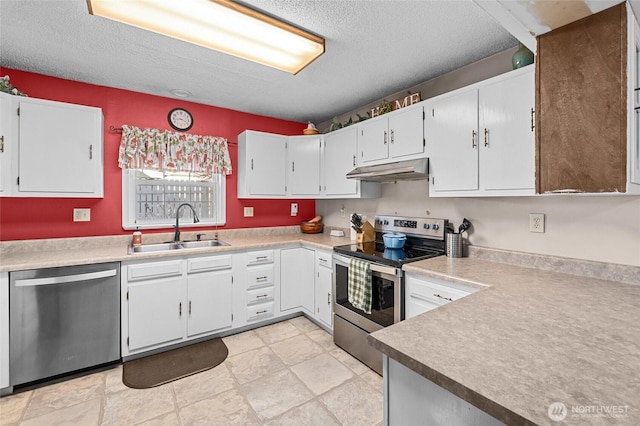 kitchen with sink, a textured ceiling, stainless steel appliances, and white cabinets