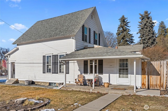 front facade featuring a porch, a patio, and a front lawn