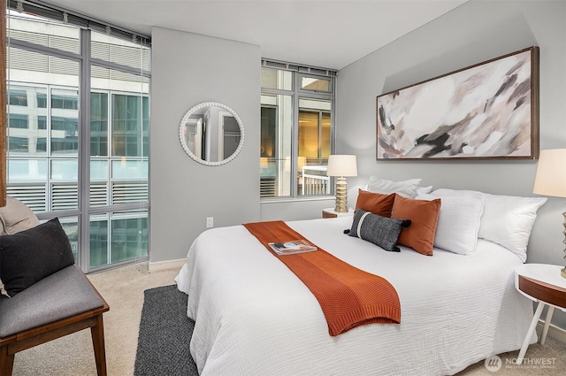 carpeted bedroom featuring access to outside and floor to ceiling windows