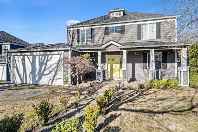 view of front of home featuring a porch and a garage