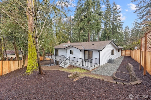 rear view of property with central AC and a deck