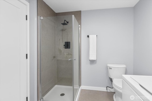 bathroom featuring toilet and a shower with door