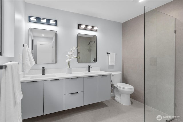 bathroom featuring vanity, toilet, tile patterned floors, and walk in shower