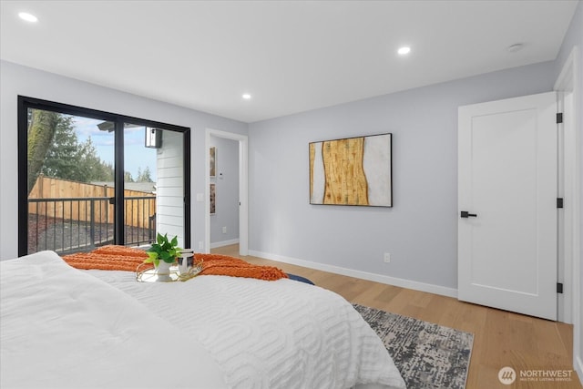 bedroom featuring light hardwood / wood-style floors and access to outside