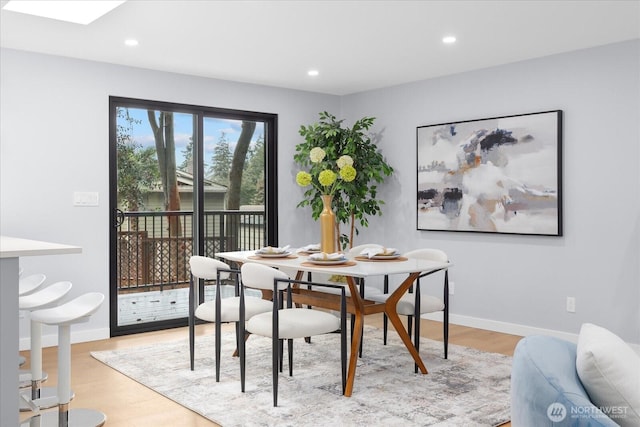 dining space with light wood-type flooring