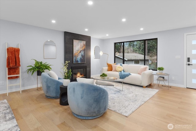 living room featuring light hardwood / wood-style floors and a fireplace