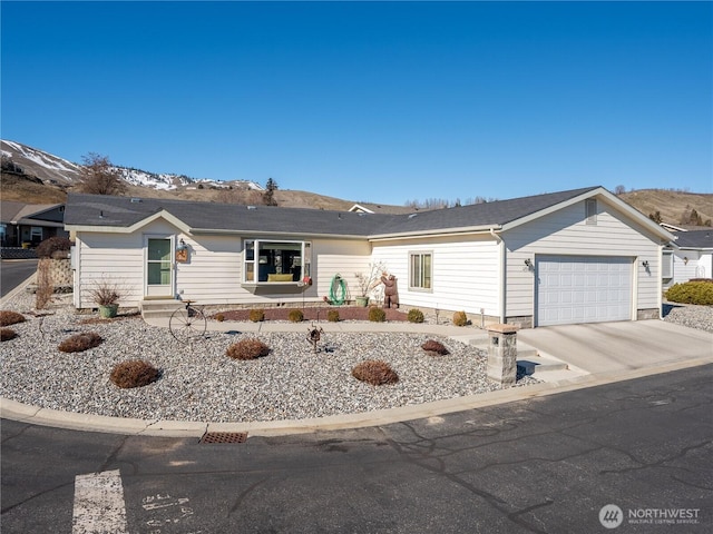 ranch-style home featuring a garage and concrete driveway