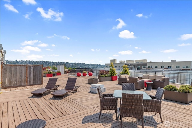 wooden terrace with an outdoor living space