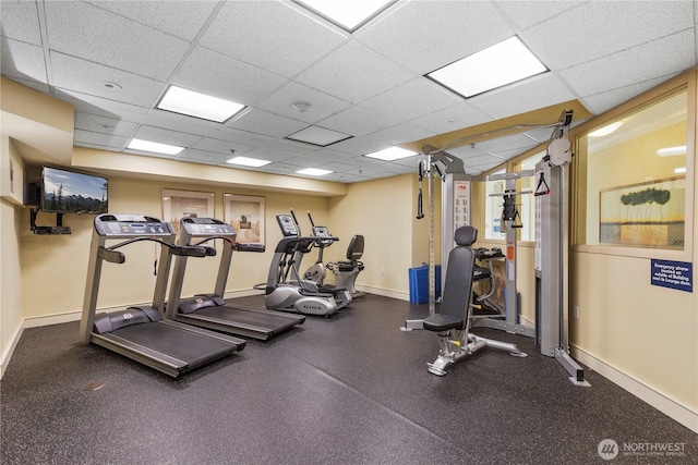 gym with a paneled ceiling