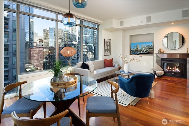 living room with hardwood / wood-style flooring and floor to ceiling windows