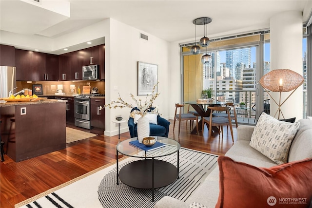 living room featuring dark hardwood / wood-style floors and expansive windows