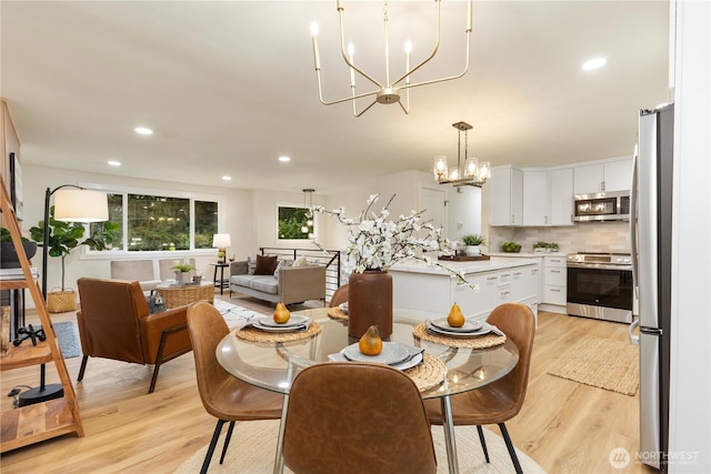 dining room featuring an inviting chandelier and light wood-type flooring