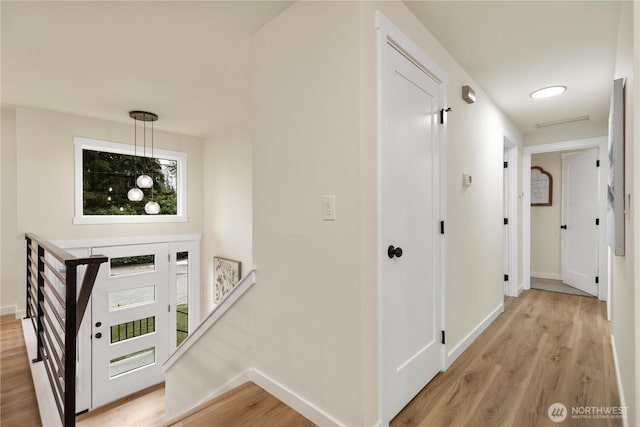 hallway with light hardwood / wood-style flooring